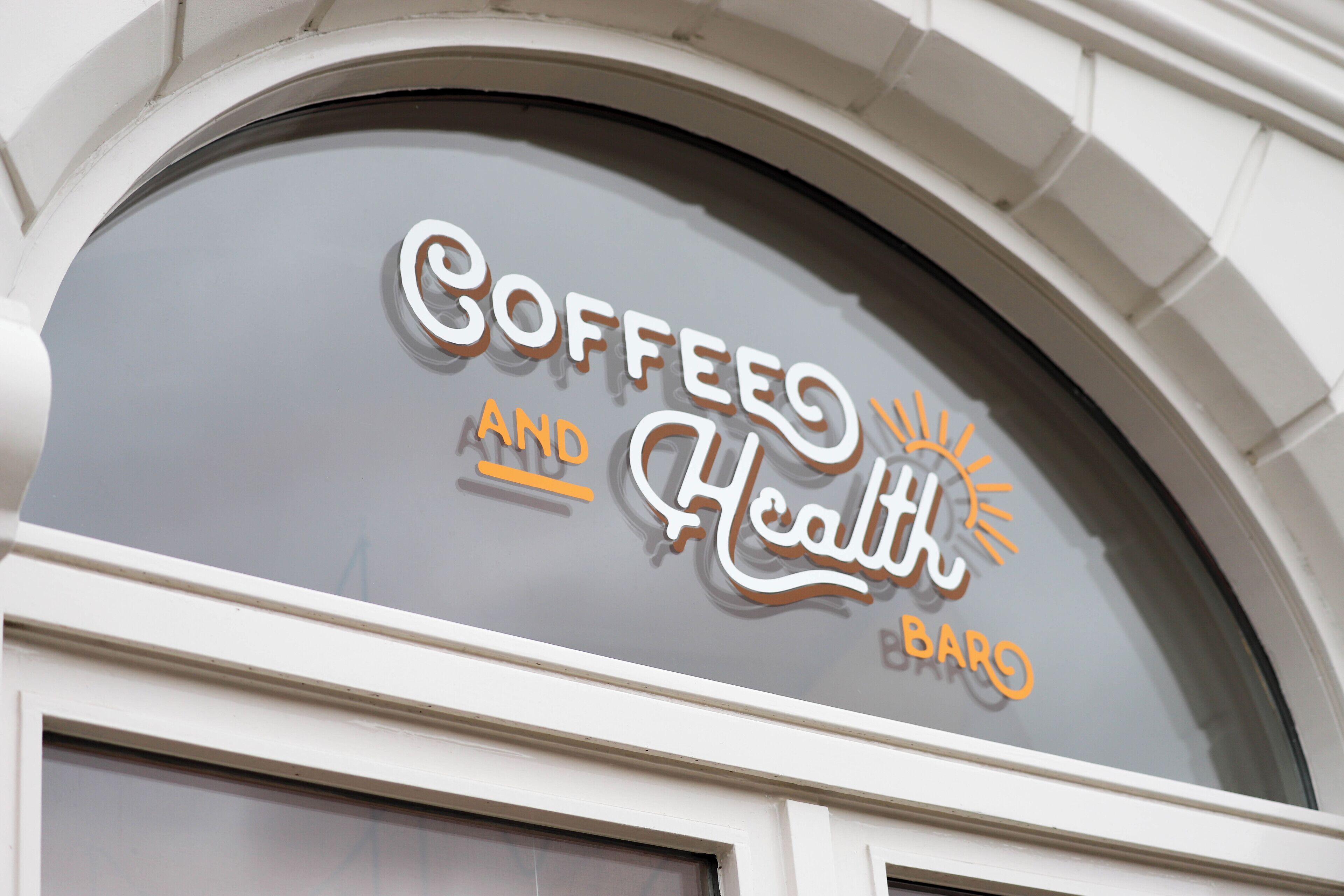 A coffee shop sign with the words "Coffee and Health Bar" in a stylized font.