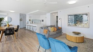 A modern living space with a kitchen, dining area, and seating area. - Oceans 14th Beachfront Resort style Living (Broadbeach)