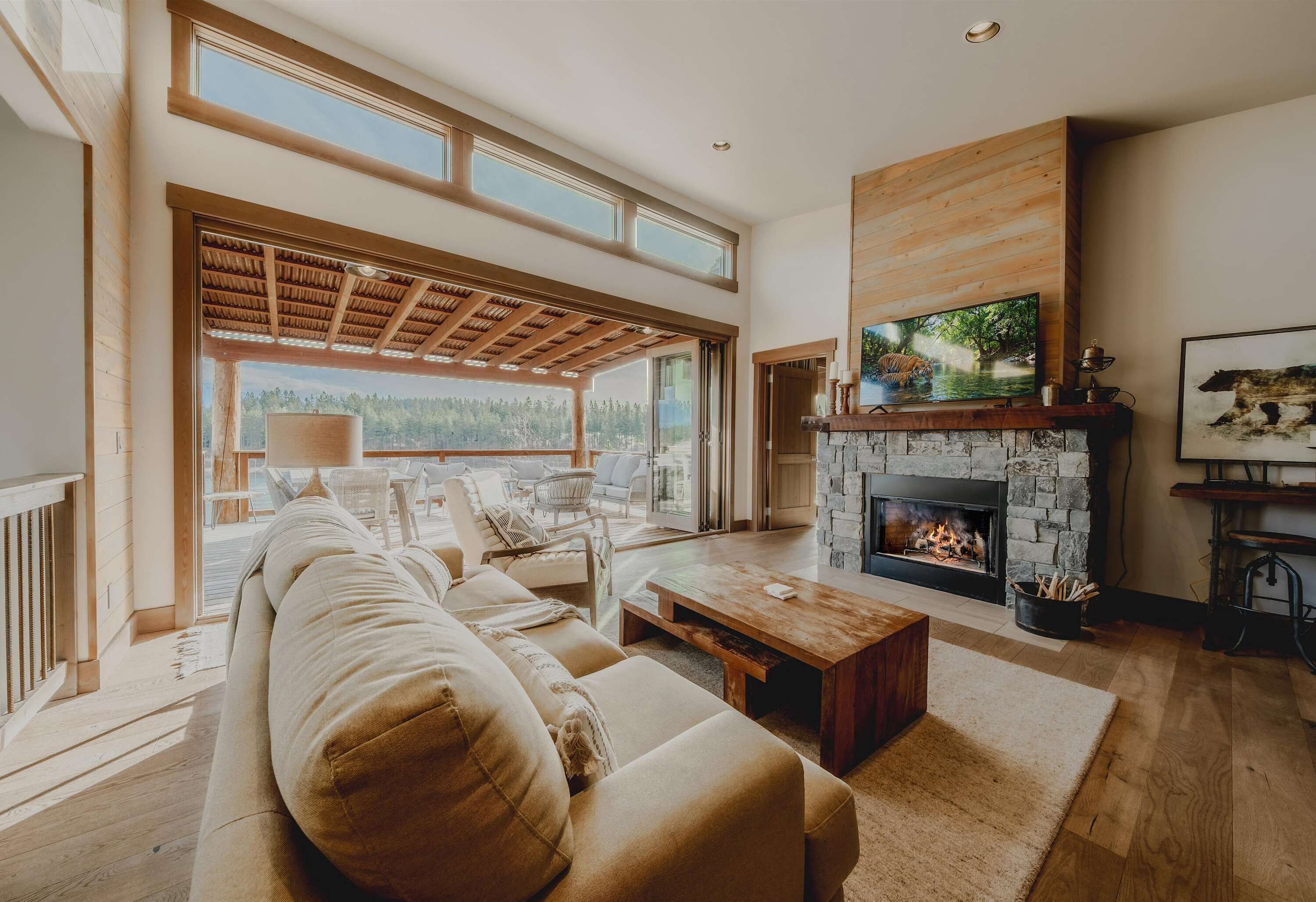 Bright open living area with wood burning fireplace, and Smart TV