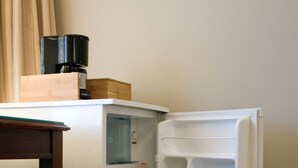 A compact refrigerator with a water dispenser, a coffee maker on top, and a small wooden box on the door. - King bed, en-suite bathroom w/separate tub/shower (Vancouver)