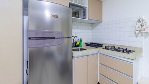 A kitchen with a stainless steel refrigerator, a countertop with a sink, and a stove. - Villa Del Mar #203- Flat With Balcony by Carpediem (Ipojuca)
