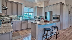 A spacious kitchen with a large island, built-in appliances, and a view of the outdoors. - 🏖️Pet Friendly | 6 Bikes | Walk to Beach | Sea Glass on 30A🏖️ (Santa Rosa Beach)