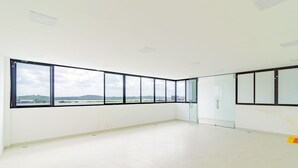 A spacious, empty room with large windows offering a view of the landscape. - Porto City #314 - Porto de Galinhas by Carpediem (Ipojuca)