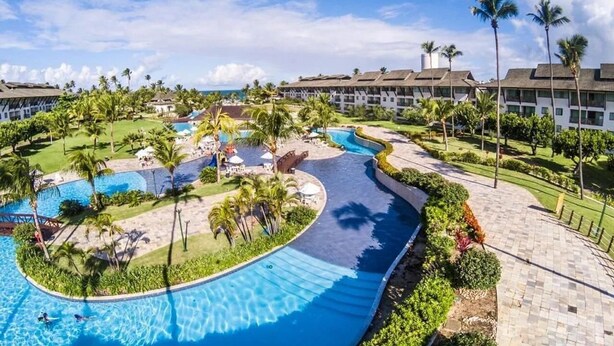 A resort with multiple swimming pools, palm trees, and a clear blue sky. - Beach Class #7113- Bungalow by Carpediem (Ipojuca)