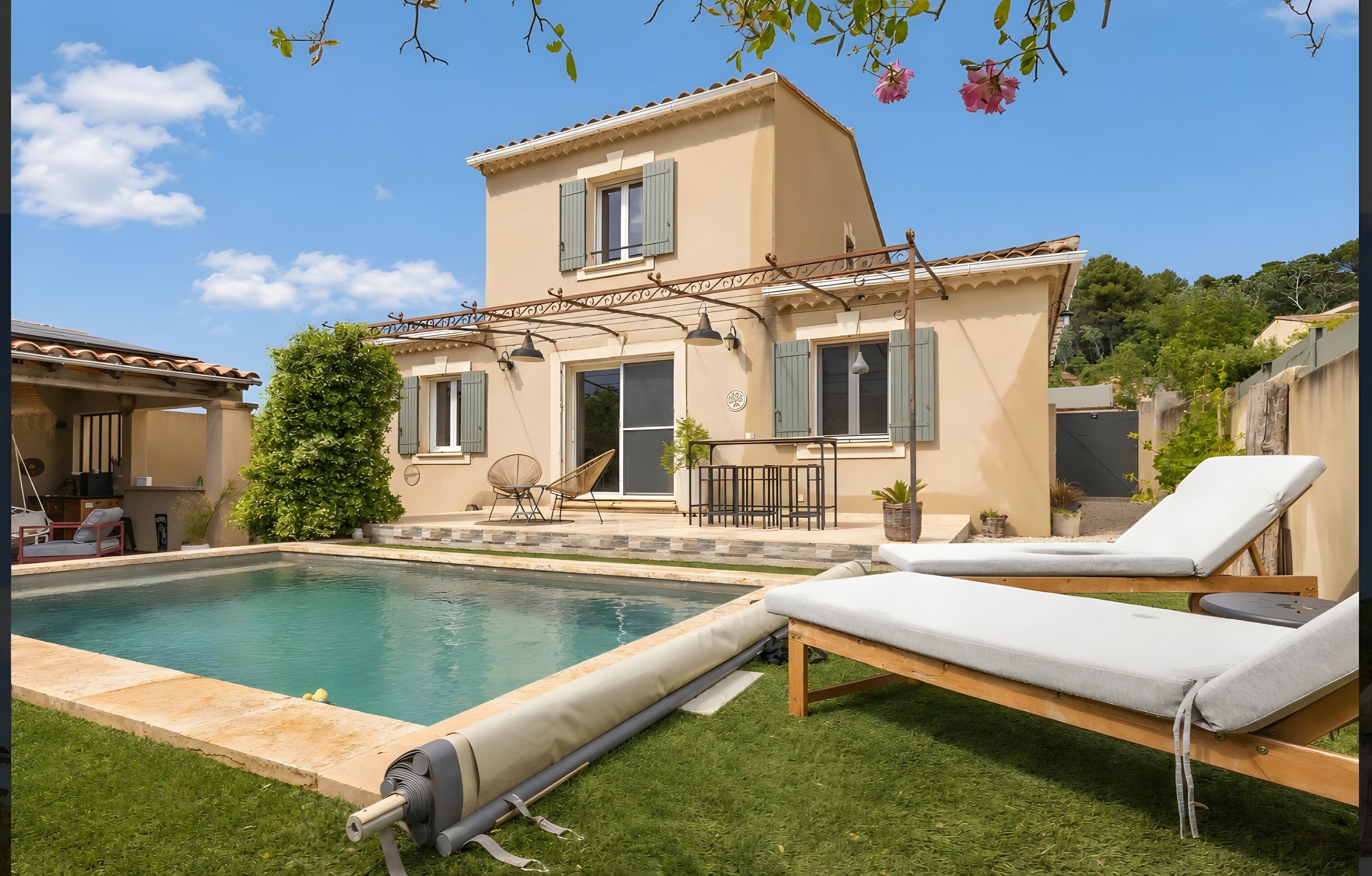 A two-story house with a swimming pool, outdoor seating, and a garden.