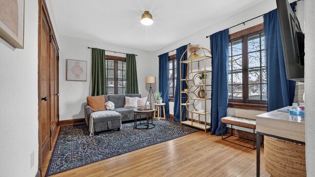 A living room with a sofa, coffee table, and a bookshelf.