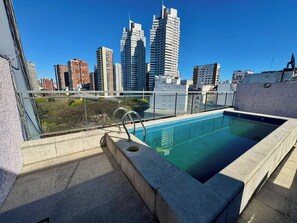 A rooftop pool with a city skyline view, surrounded by high-rise buildings. - Parque Las Heras: Jewel between Palermo & Recoleta (Buenos Aires)