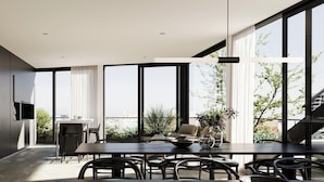 A modern dining area with a large table, chairs, and a hanging light fixture. - Palermo Portẽnito: A Cosmopolitan Nomad Oasis (Buenos Aires)