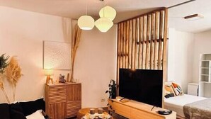 A modern living room with a black sofa, wooden coffee table, and a TV stand. - Plaza Serrano: Japandi -epicenter nest by airesB&B (Buenos Aires)