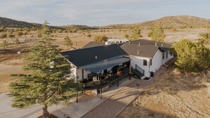 A white building with a covered patio and a fenced area. - Triangle Ranch - Private West Texas Retreat (Alpine)