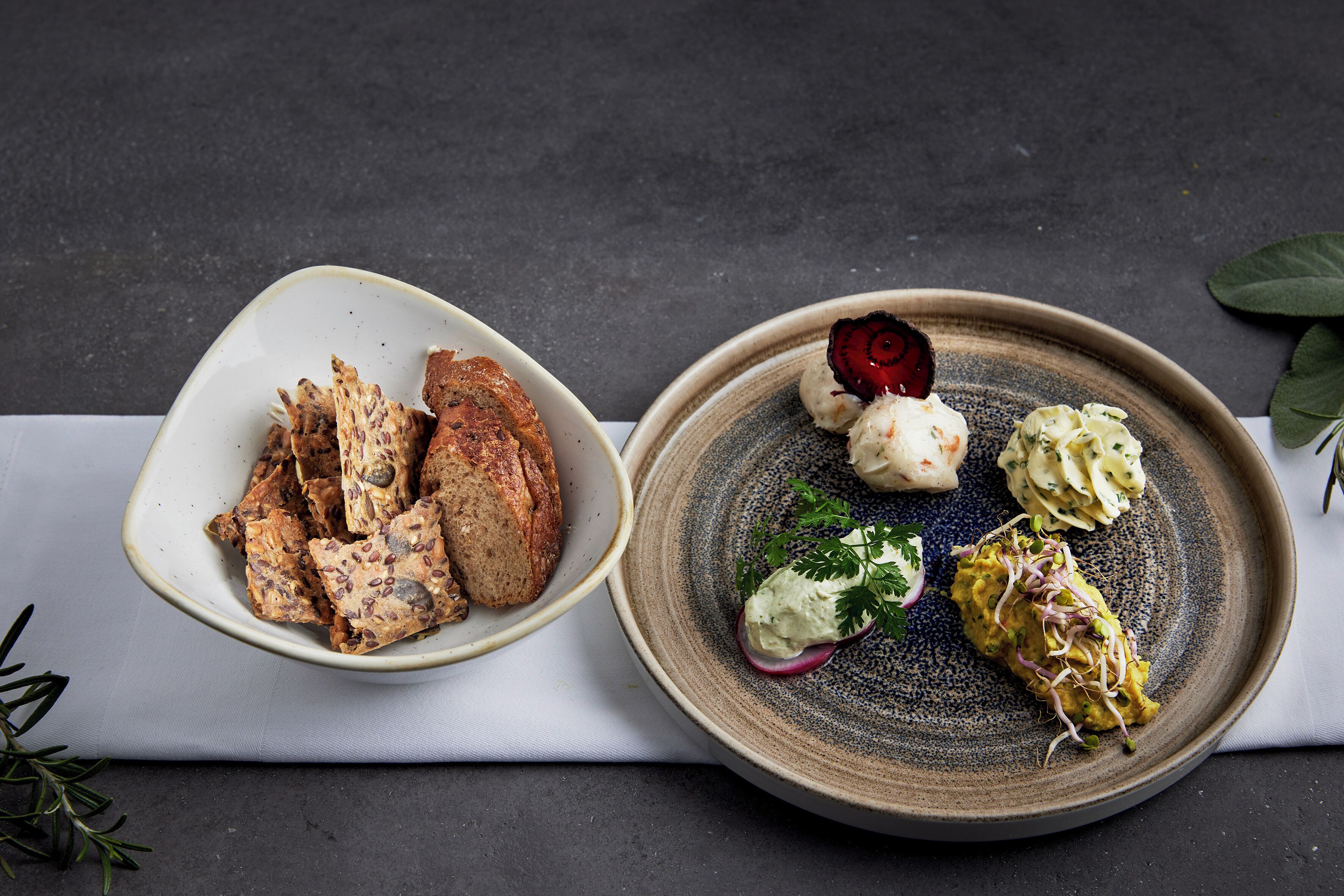 Two bowls of food on a table with a dark background.