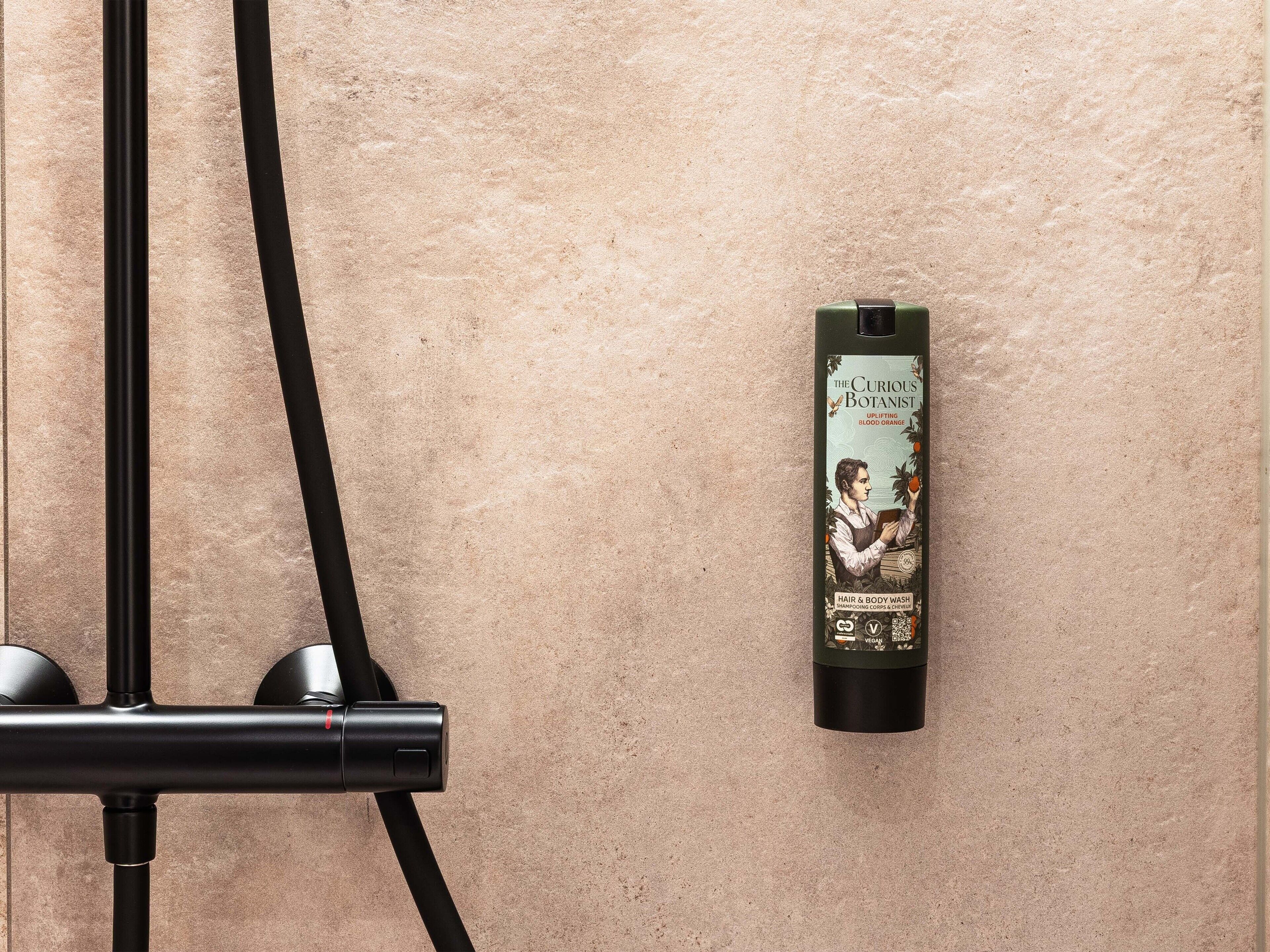 A hair care product on a textured wall.