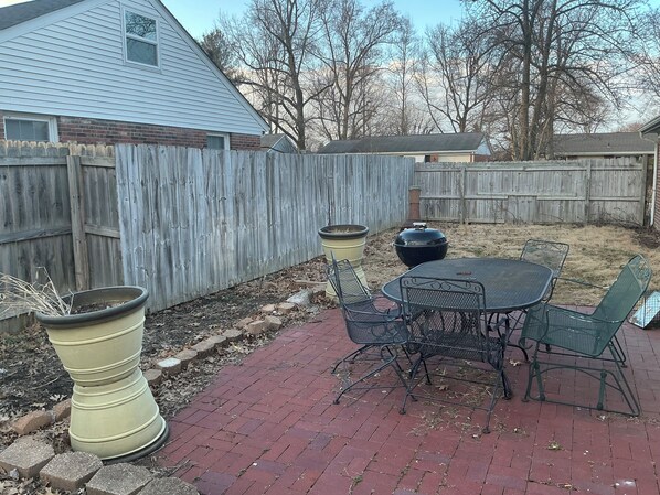 A patio with a table and chairs, a large planter, and a barbecue grill. - PERFECT MIAMI STAY 4-bedroom 2 bath with luxury shower in O (Oxford)