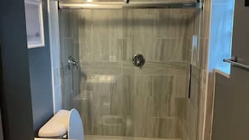Shower, hair dryer, towels, toilet paper