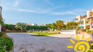 A courtyard with a swimming pool, surrounded by buildings and greenery. - Santa Luzia Mar 2BDR | Pool | Wi-Fi | BBQ (Santa Luzia Tavira)