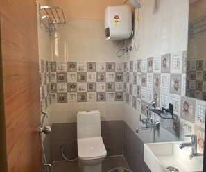 A bathroom with a toilet, sink, and shower. - Townhouse Kanithi Road (Visakhapatnam)