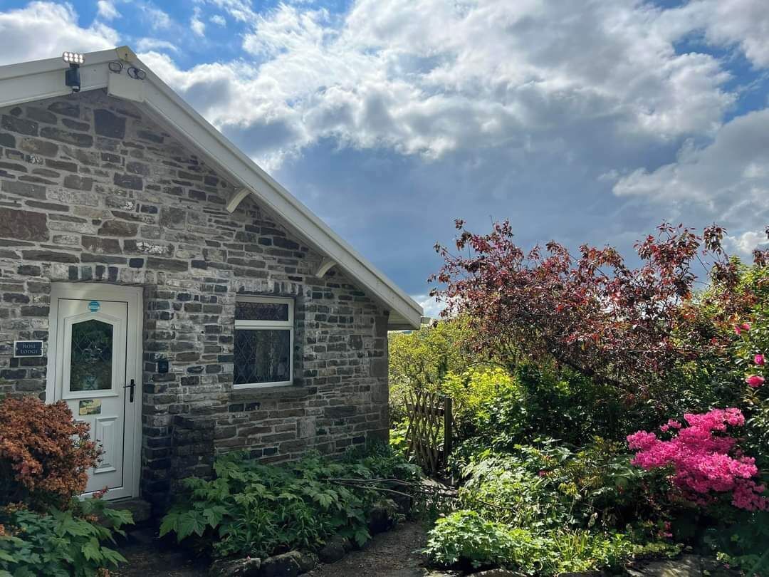A stone building with a white door and a small window.