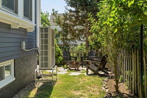 A backyard with a patio, outdoor furniture, a fire pit, and a fence. - State St. Parlor | Walk Downtown | Newly Designed (Portsmouth)