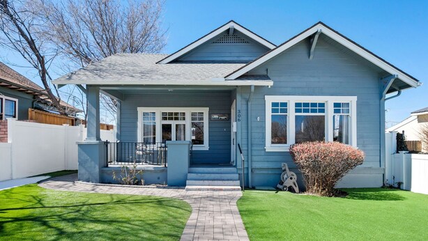 A two-story house with a front porch, a brick pathway leading to the entrance, and a well-maintained lawn. - Historic Prescott Craftsman | Walk Downtown (Prescott)