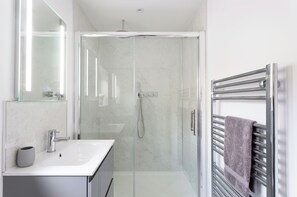 Shower, hair dryer, towels, soap