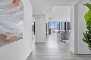 A modern interior with a hallway leading to a living area with a city view. - X Lounge VII 3BR/3 Ensuite/Private Sky Residence (Miami)
