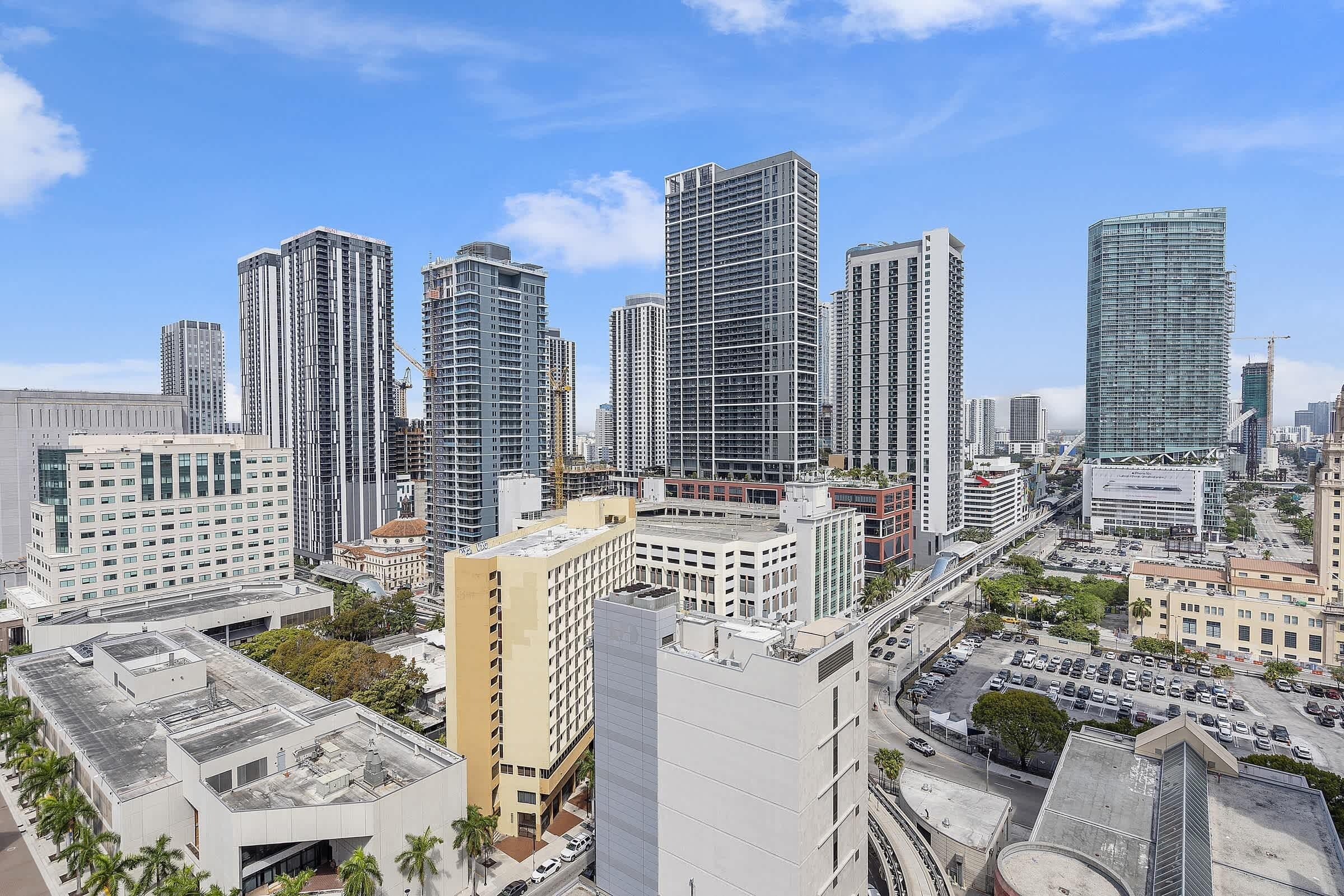 A high-rise urban area with modern buildings, roads, and a clear sky.
