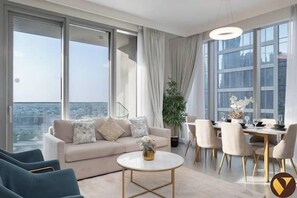 Luxury Apartment, Balcony, City View | Living area | 65-inch Smart TV with cable channels, foosball - Vogue | Forte Downtown near Dubai Mall | Burj Khalifa (Dubai)