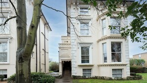 A traditional building with a central entrance, large windows, and a symmetrical facade. - Stunning 1 BR Surbiton with views, near station - Pass the Keys (Surbiton)