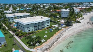 Un resort con varias edificaciones, una playa y una zona de piscina.