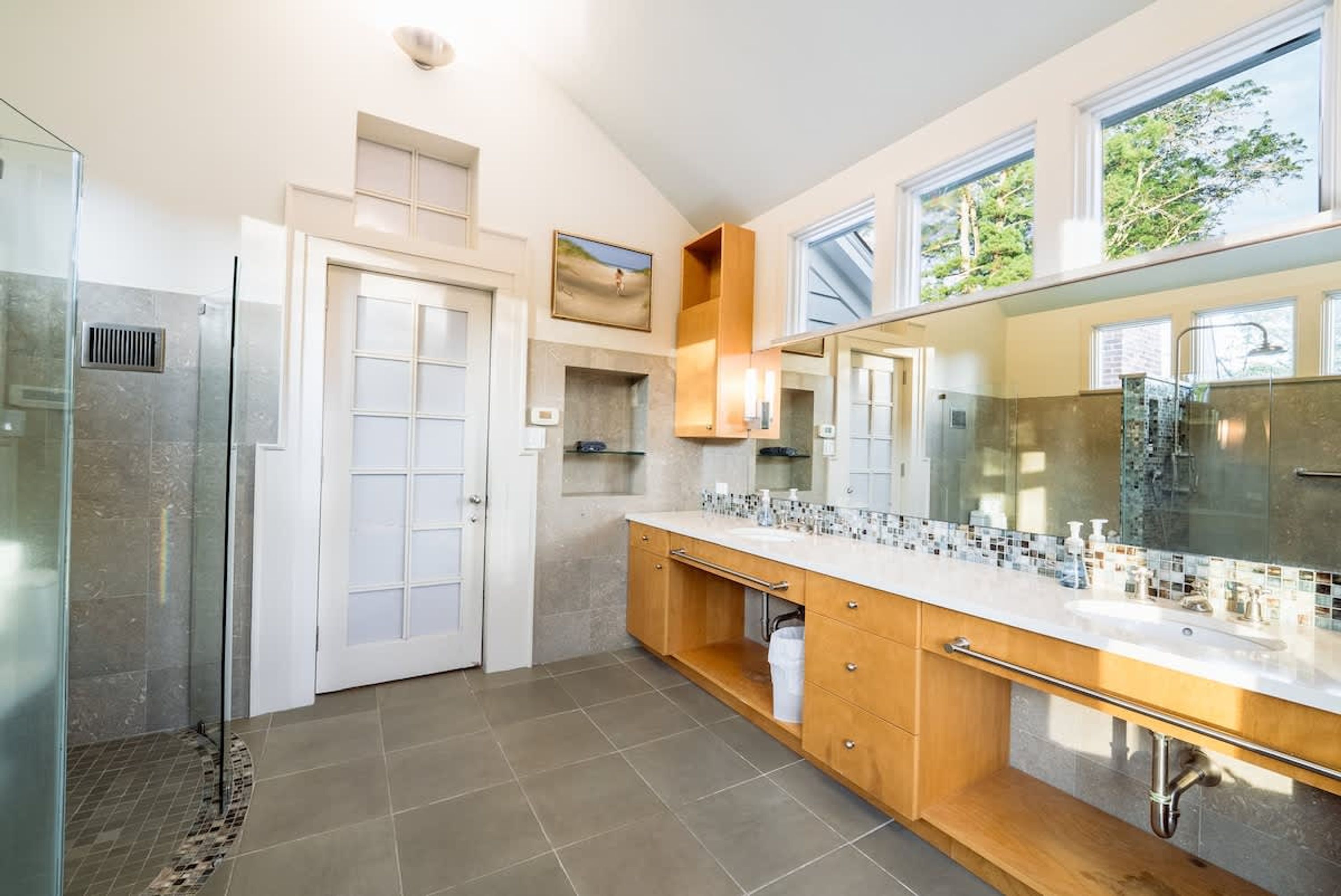 A modern kitchen with a large island, a double sink, and a built-in oven.