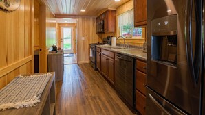 A kitchen with wooden cabinets, stainless steel appliances, and a granite countertop.