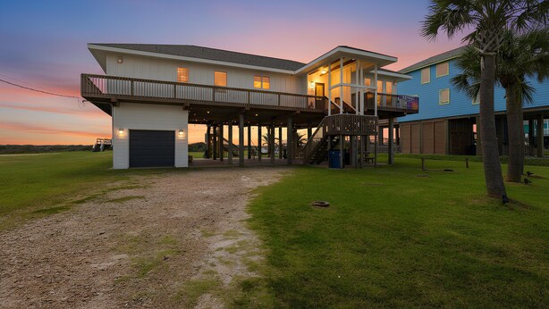 A two-story house with a covered porch and a separate building with a balcony. - Casa Bonita Surfside (Freeport)
