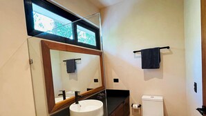 A bathroom with a white sink, a mirror, a toilet, and a towel rack. - Tulum Studio Jungle Pool S14 (Tulum)