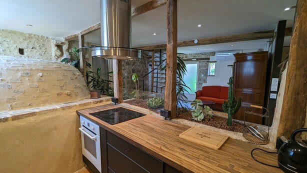 A kitchen with a built-in stove, wooden countertop, and a stainless steel range hood. - Charming country house with garden - 7 guests (Courtemaux)