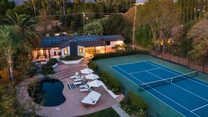 A residential property with a tennis court, swimming pool, and a house with solar panels. - Private Estate: House + Cottage, Pool & Tennis (Ojai)