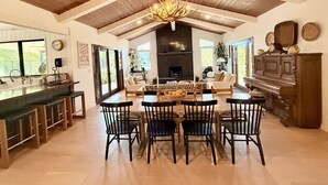 A spacious kitchen with a dining area, wooden ceiling, and a fireplace. - Private Estate: House + Cottage, Pool & Tennis (Ojai)