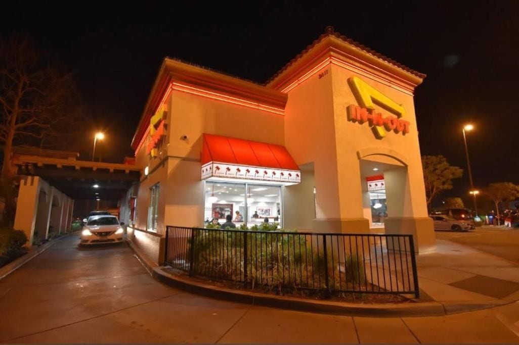 A brightly lit building with a red awning and a sign that reads "In-N-Out."
