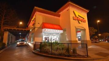 A brightly lit building with a red awning and a sign that reads "In-N-Out."
