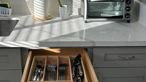A kitchen with a toaster, a plant, and a drawer organizer with utensils. - Walkable to SoFi, Intuit Dome, Kia Forum World Cup (Lennox)