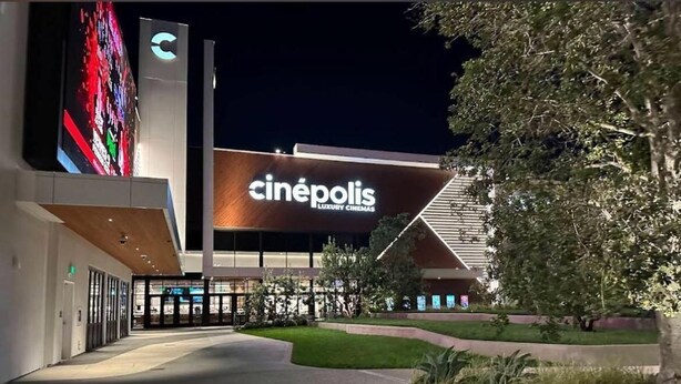 A modern cinema building with a prominent 'cinépolis' sign, a well-lit entrance, and landscaped surroundings. - Walkable to SoFi, Intuit Dome, Kia Forum World Cup (Lennox)