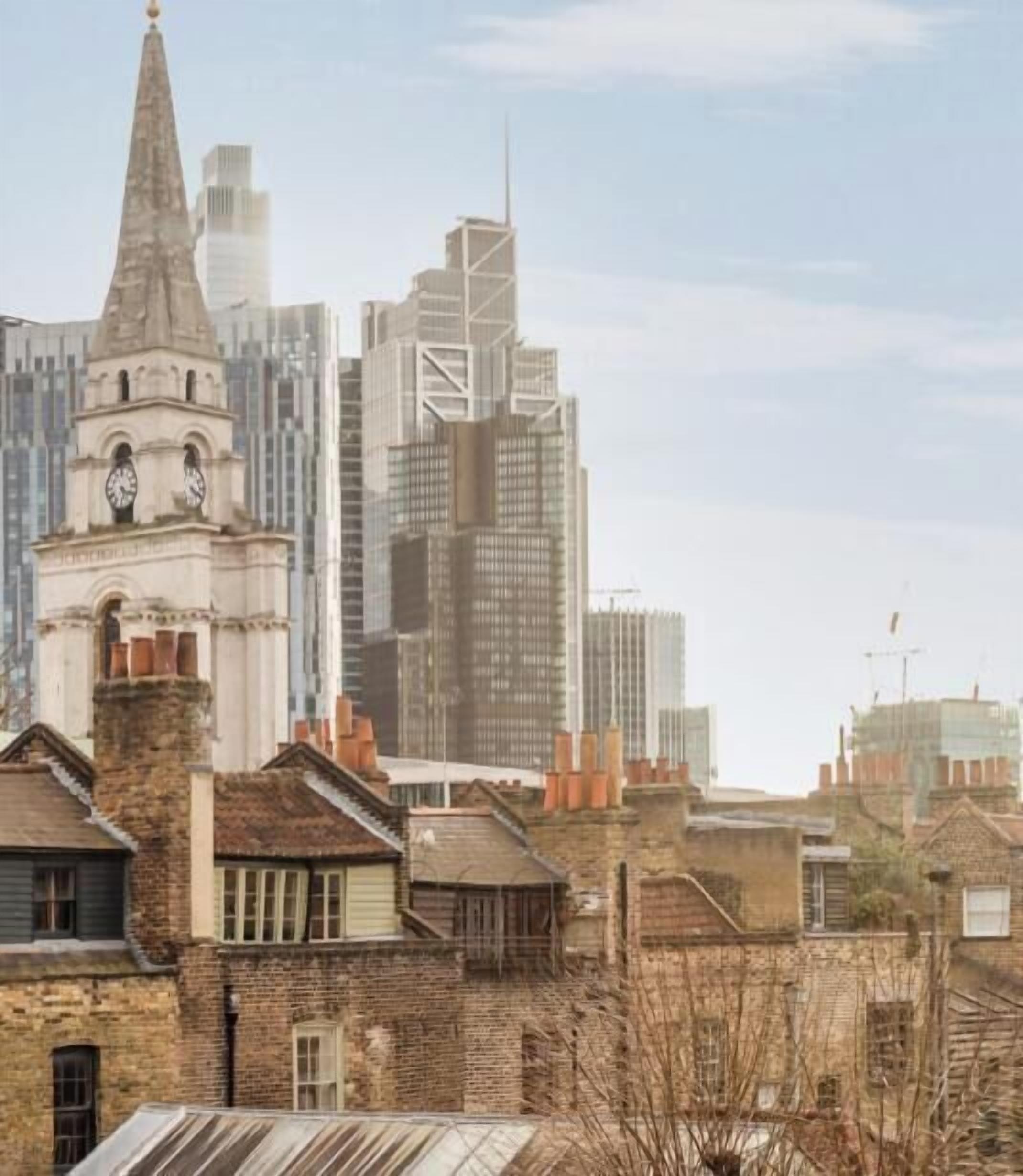 A cityscape with historic buildings and modern skyscrapers.