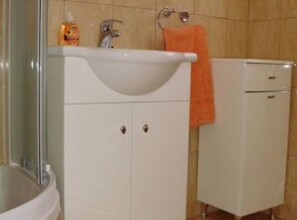 A bathroom with a sink, cabinets, and a small refrigerator. - Apartments Kiki Lumbarda (Lumbarda)