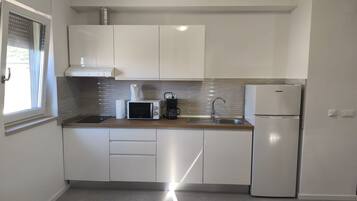 Apartment (Superior One Bedroom Apartment with B) | Private kitchen | Fridge