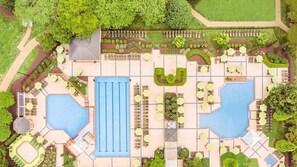 A resort with two large pools, sun loungers, and a central building with a blue roof. - 2 bdrm with full kitchen (Williamsburg)