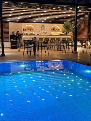 Ein Poolbereich mit Bar und Sitzgelegenheiten.