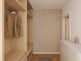A modern, minimalist walk-in closet with wooden shelves and a neutral-colored wall.