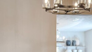 A modern dining area with a round table, four chairs, and a chandelier. - Holbrook ~ Cozy Guest Retreat (Knoxville)