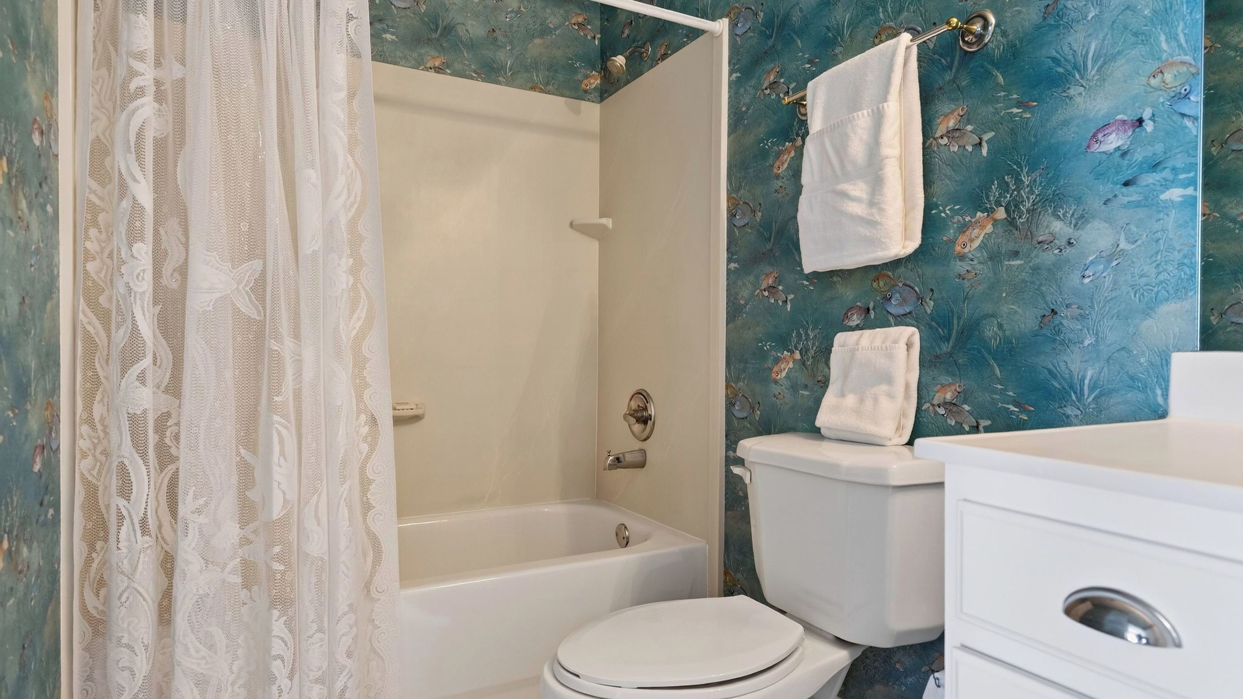 A bathroom with a bathtub, toilet, and sink.