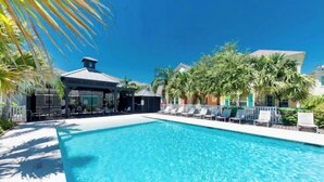 A swimming pool with lounge chairs and a covered area with tables and chairs. - BEACH THERAPY: Lovely Spacious and Comfortable Coastal Family Retreat (Rockport)