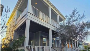 A two-story house with a front porch, a wooden deck, and a private entrance sign. - BEACH THERAPY: Lovely Spacious and Comfortable Coastal Family Retreat (Rockport)